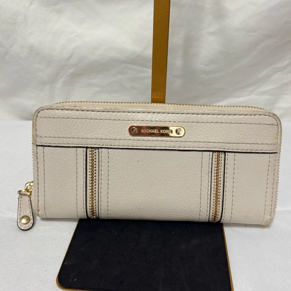 Michael Kors Moxley continental zip-around wallet in vanilla or cream leather.